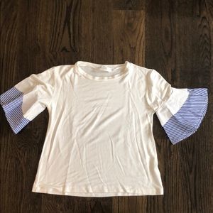 White top with blue puffy sleeve cuffs